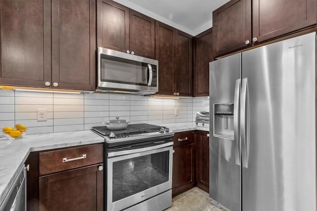 5006 Lott Ave Unit 2, Austin, TX 78721 - kitchen featuring appliances with stainless steel finishes, tasteful backsplash, light stone counters, and dark brown cabinetry