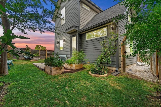 5006 Lott Ave Unit 2, Austin, TX 78721 - property exterior at dusk featuring a garden and roof with shingles