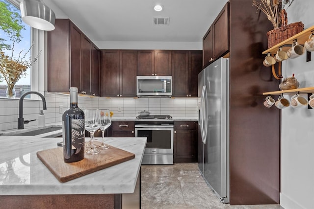5006 Lott Ave Unit 2, Austin, TX 78721 - kitchen with appliances with stainless steel finishes, healthy amount of natural light, and light countertops