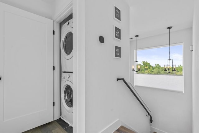 5006 Lott Ave Unit 2, Austin, TX 78721 - laundry area with stacked washing machine and dryer, a chandelier, and dark wood-style flooring