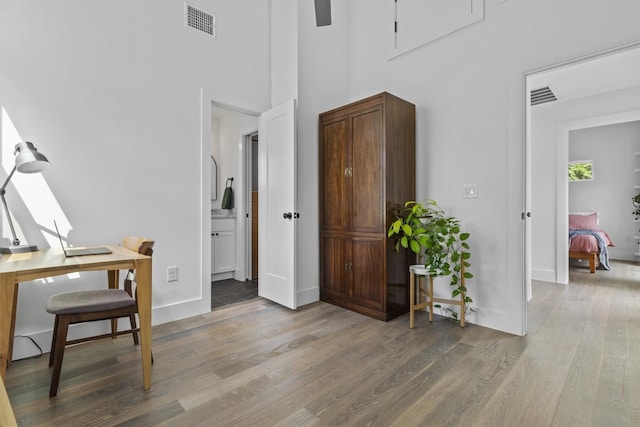 5006 Lott Ave Unit 2, Austin, TX 78721 - office area featuring wood finished floors and a high ceiling