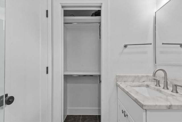 5006 Lott Ave Unit 2, Austin, TX 78721 - bathroom featuring vanity, tile patterned floors, and a walk in closet