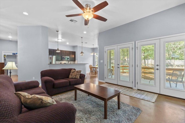 227 Kaelepulu Dr, Bastrop, TX 78602 - living area featuring french doors, healthy amount of natural light, ceiling fan, recessed lighting, and finished concrete floors