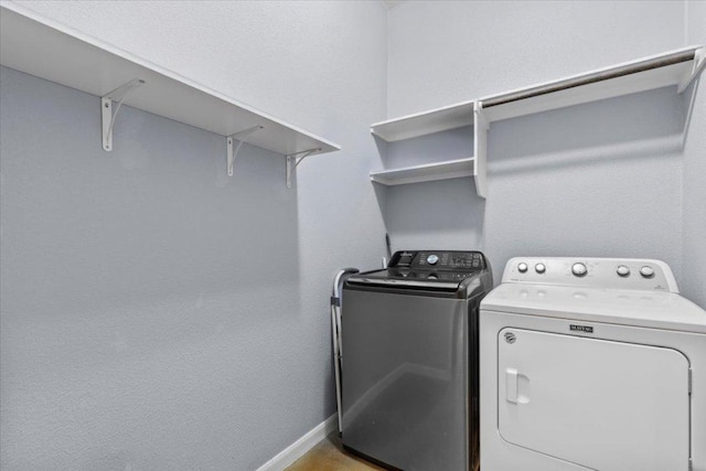 227 Kaelepulu Dr, Bastrop, TX 78602 - laundry room featuring separate washer and dryer and baseboards