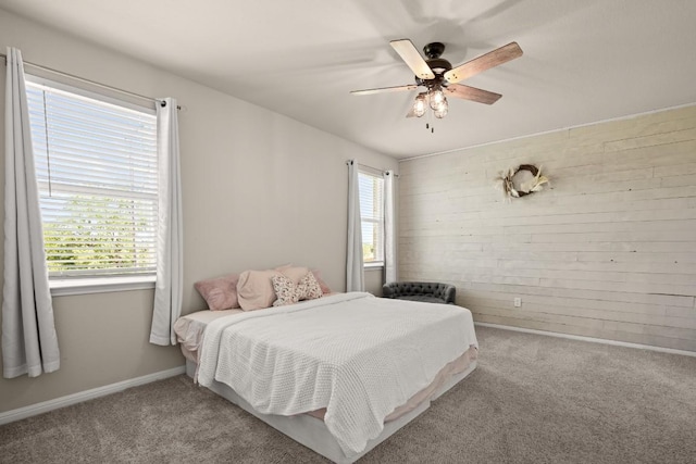 649 Otto Ave, Georgetown, TX 78626 - bedroom with carpet floors, wooden walls, and a ceiling fan
