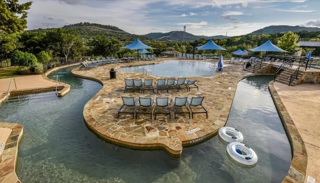 963 Tomichi Trl, Lakeway, TX 78738 - community pool with a mountain view and a patio
