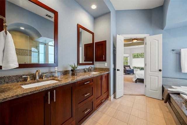 10908 Sans Souci Pl, Austin, TX 78759 - full bath with double vanity, a tile shower, a tub to relax in, tile patterned floors, and a ceiling fan
