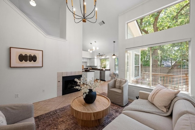 11305 Deputy Dr, Austin, TX 78748 - tiled living room with a chandelier, a towering ceiling, and a tile fireplace