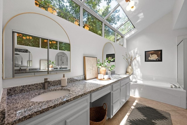 11305 Deputy Dr, Austin, TX 78748 - bathroom with a skylight, double vanity, tile patterned floors, high vaulted ceiling, and a bath