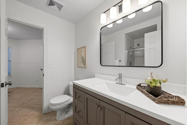 11305 Deputy Dr, Austin, TX 78748 - bathroom featuring vanity, a shower with shower door, and tile patterned flooring
