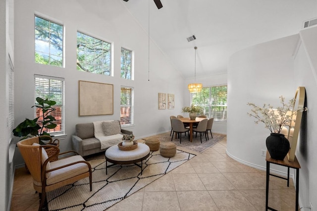 11305 Deputy Dr, Austin, TX 78748 - living room featuring high vaulted ceiling, light tile patterned floors, a ceiling fan, and a chandelier
