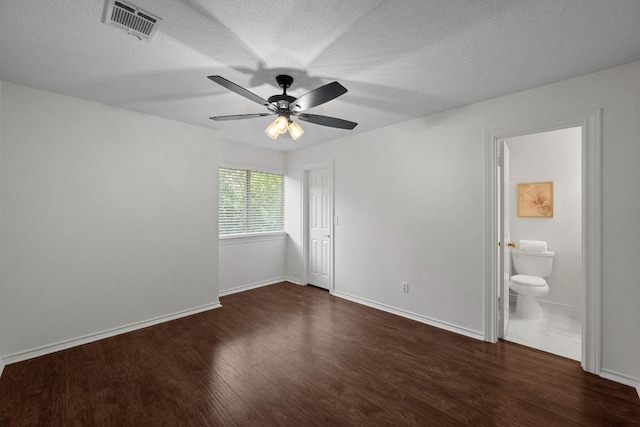 11305 Deputy Dr, Austin, TX 78748 - unfurnished bedroom with wood finished floors, a textured ceiling, ensuite bathroom, and a ceiling fan