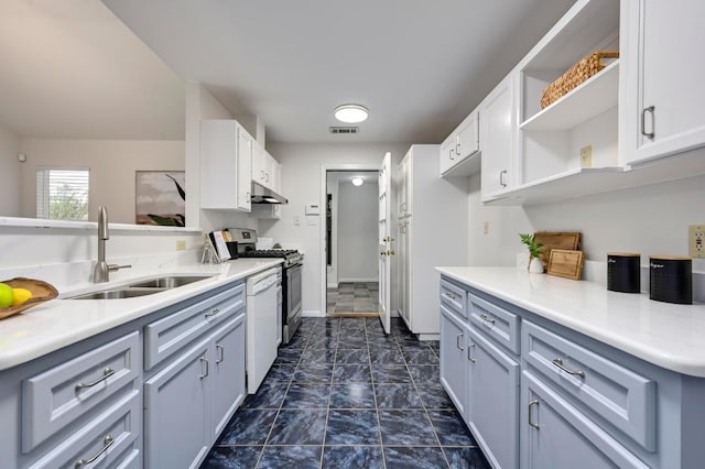 6102 Laird Dr, Austin, TX 78757 - kitchen featuring under cabinet range hood, open shelves, white dishwasher, stainless steel gas range oven, and light countertops