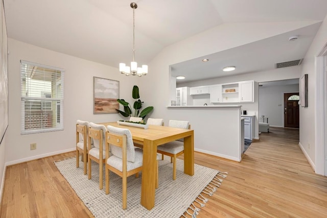 6102 Laird Dr, Austin, TX 78757 - dining area featuring vaulted ceiling, a chandelier, and light wood-type flooring