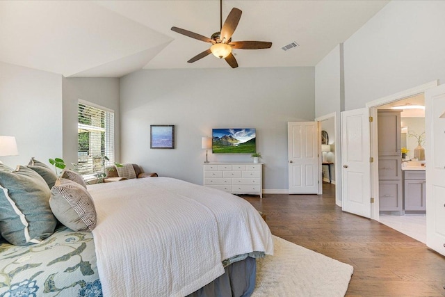 280 Whitney Run, Buda, TX 78610 - bedroom with high vaulted ceiling, wood finished floors, ensuite bathroom, and ceiling fan