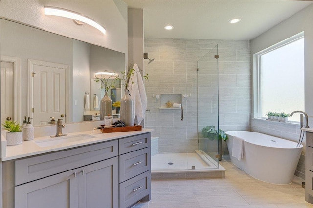 280 Whitney Run, Buda, TX 78610 - bathroom with a stall shower, vanity, a soaking tub, recessed lighting, and tile patterned flooring