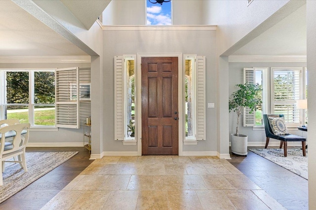280 Whitney Run, Buda, TX 78610 - entrance foyer featuring stone tile flooring, ornamental molding, and a towering ceiling