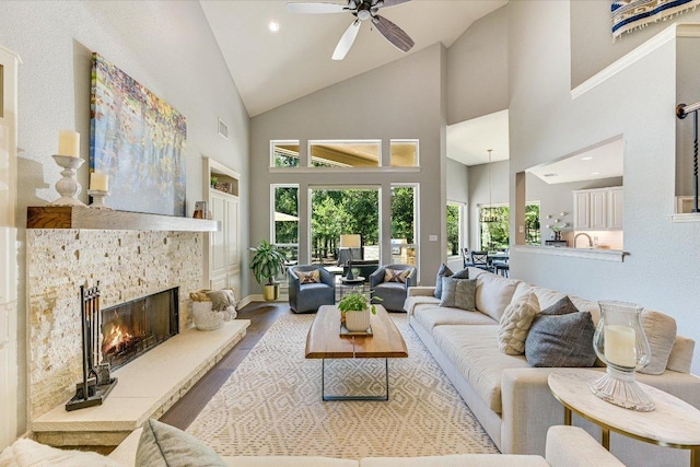 280 Whitney Run, Buda, TX 78610 - living room featuring wood finished floors, a ceiling fan, a fireplace, high vaulted ceiling, and recessed lighting