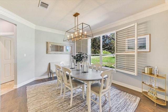 280 Whitney Run, Buda, TX 78610 - dining area featuring ornamental molding, a chandelier, and wood finished floors