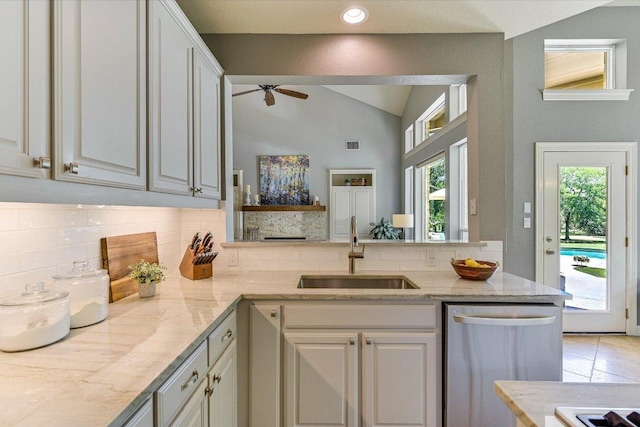 280 Whitney Run, Buda, TX 78610 - kitchen featuring stainless steel dishwasher, backsplash, vaulted ceiling, a ceiling fan, and light stone countertops