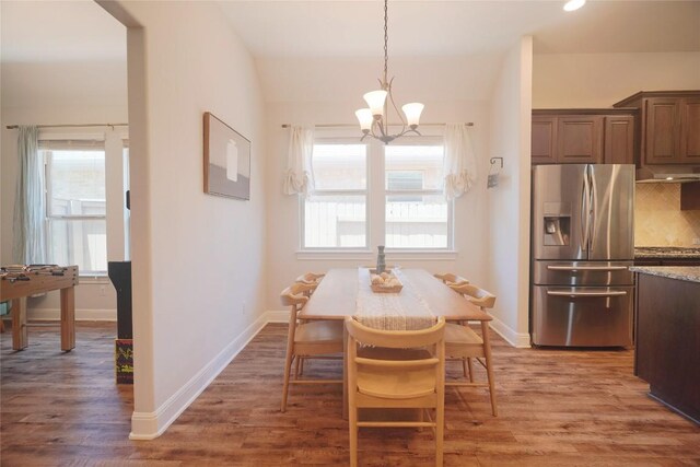 2301 Yaupon Range Dr, Leander, TX 78641 - dining area featuring a chandelier and wood finished floors