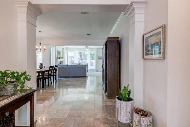 8500 E Potosi Cv, Austin, TX 78717 - corridor featuring light marble finish floors, ornamental molding, and a chandelier
