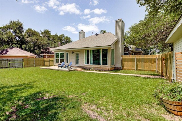 8500 E Potosi Cv, Austin, TX 78717 - rear view of house with a chimney, a fenced backyard, and a patio area