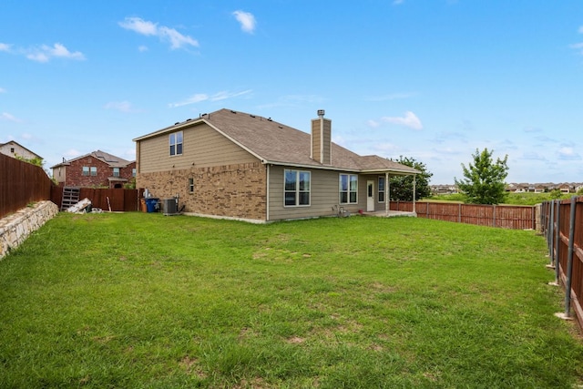 12000 Kincardine Way, Austin, TX 78754 - back of house with a fenced backyard, a chimney, and brick siding