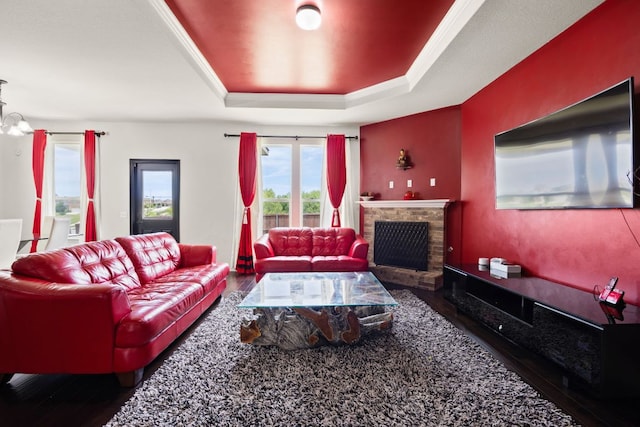 12000 Kincardine Way, Austin, TX 78754 - living room featuring a tray ceiling, wood finished floors, and a brick fireplace