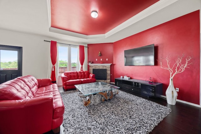 12000 Kincardine Way, Austin, TX 78754 - living room featuring wood finished floors, a fireplace, and a raised ceiling