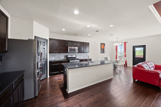 12000 Kincardine Way, Austin, TX 78754 - kitchen featuring appliances with stainless steel finishes, backsplash, dark wood-type flooring, dark brown cabinetry, and open floor plan