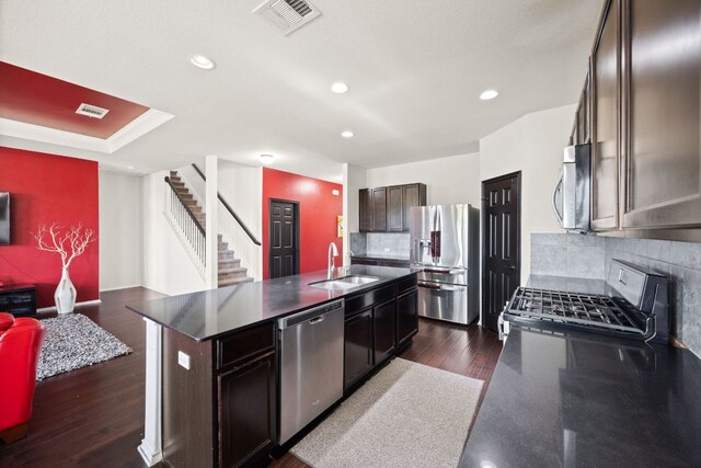 12000 Kincardine Way, Austin, TX 78754 - kitchen featuring appliances with stainless steel finishes, dark countertops, recessed lighting, backsplash, and dark brown cabinetry