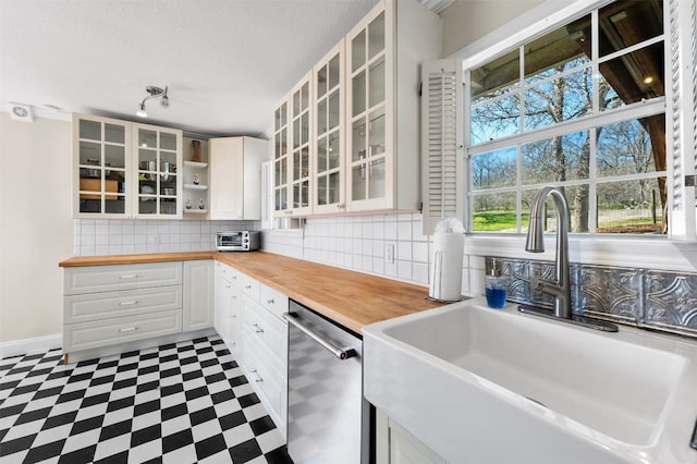 175 Settlers Trl, Elgin, TX 78621 - kitchen with dishwasher, wood counters, tile patterned floors, tasteful backsplash, and white cabinetry