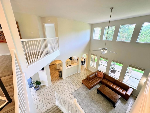 12504 Gun Metal Dr, Austin, TX 78739 - living room with healthy amount of natural light, ceiling fan, and a towering ceiling