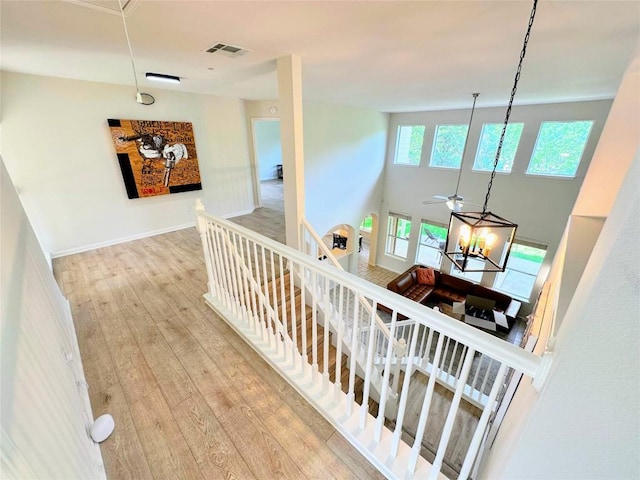 12504 Gun Metal Dr, Austin, TX 78739 - hall with an upstairs landing, attic access, and wood finished floors