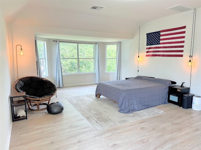 12504 Gun Metal Dr, Austin, TX 78739 - bedroom featuring wood finished floors, multiple windows, and lofted ceiling