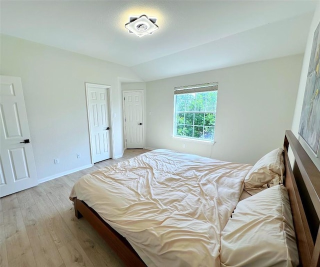12504 Gun Metal Dr, Austin, TX 78739 - bedroom featuring light wood-style floors and vaulted ceiling