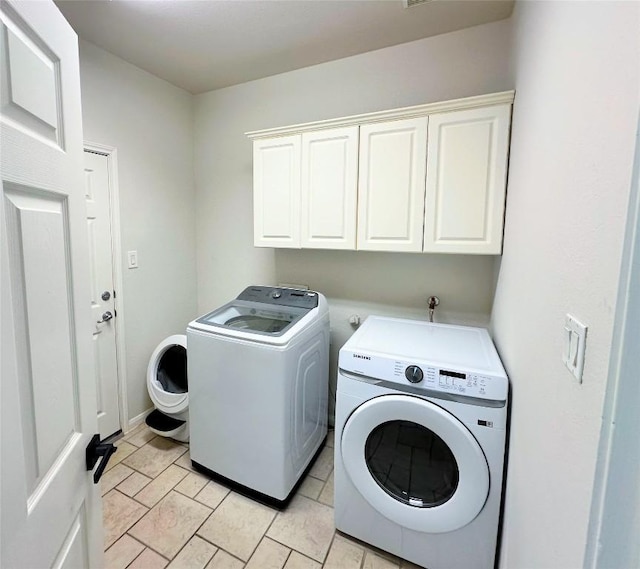 12504 Gun Metal Dr, Austin, TX 78739 - laundry area with cabinet space and washer and clothes dryer
