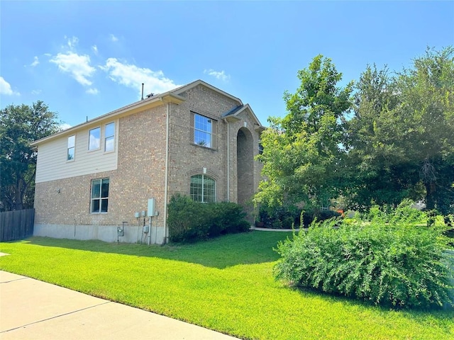 12504 Gun Metal Dr, Austin, TX 78739 - view of home's exterior with brick siding and a lawn
