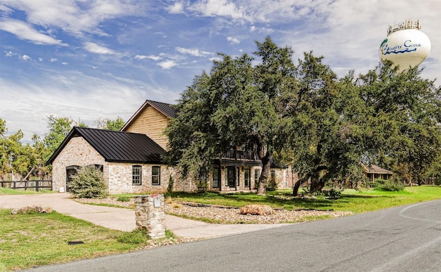 4204 Deer Tract St, Round Rock, TX 78681 - view of front of house with a standing seam roof, driveway, a metal roof, and a garage
