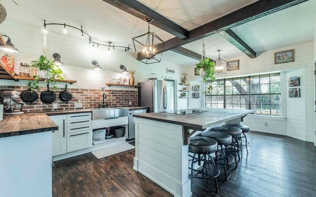4204 Deer Tract St, Round Rock, TX 78681 - kitchen with appliances with stainless steel finishes, wood counters, a chandelier, dark wood finished floors, and beamed ceiling