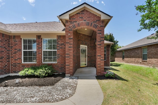 3713 Eagle Fledge Ter, Pflugerville, TX 78660 - property entrance with brick siding, a yard, and a shingled roof