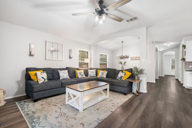 3713 Eagle Fledge Ter, Pflugerville, TX 78660 - living room featuring arched walkways, plenty of natural light, dark wood-style flooring, a chandelier, and vaulted ceiling