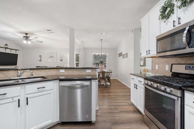 3713 Eagle Fledge Ter, Pflugerville, TX 78660 - kitchen with appliances with stainless steel finishes, backsplash, wood finished floors, white cabinetry, and a ceiling fan