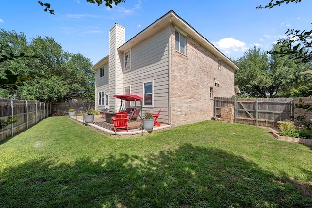 1913 Avante Dr, Cedar Park, TX 78613 - rear view of house featuring a fenced backyard, a chimney, a patio area, and brick siding