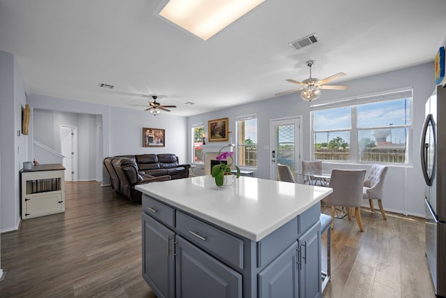 1913 Avante Dr, Cedar Park, TX 78613 - kitchen featuring ceiling fan, freestanding refrigerator, dark wood-type flooring, a center island, and light countertops