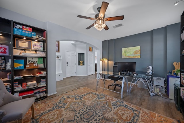 1913 Avante Dr, Cedar Park, TX 78613 - home office featuring arched walkways, ceiling fan, and wood finished floors