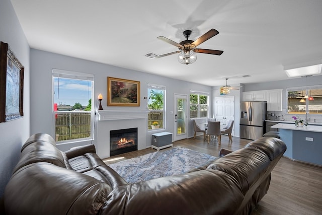 1913 Avante Dr, Cedar Park, TX 78613 - living area featuring ceiling fan, dark wood finished floors, and a glass covered fireplace