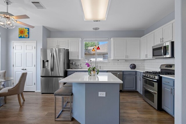 1913 Avante Dr, Cedar Park, TX 78613 - kitchen featuring appliances with stainless steel finishes, a ceiling fan, decorative backsplash, and dark wood-style flooring
