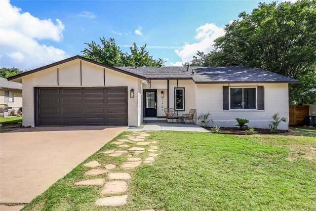 2402 Broken Oak Dr, Austin, TX 78745 - ranch-style house with a garage, concrete driveway, brick siding, a front lawn, and a shingled roof